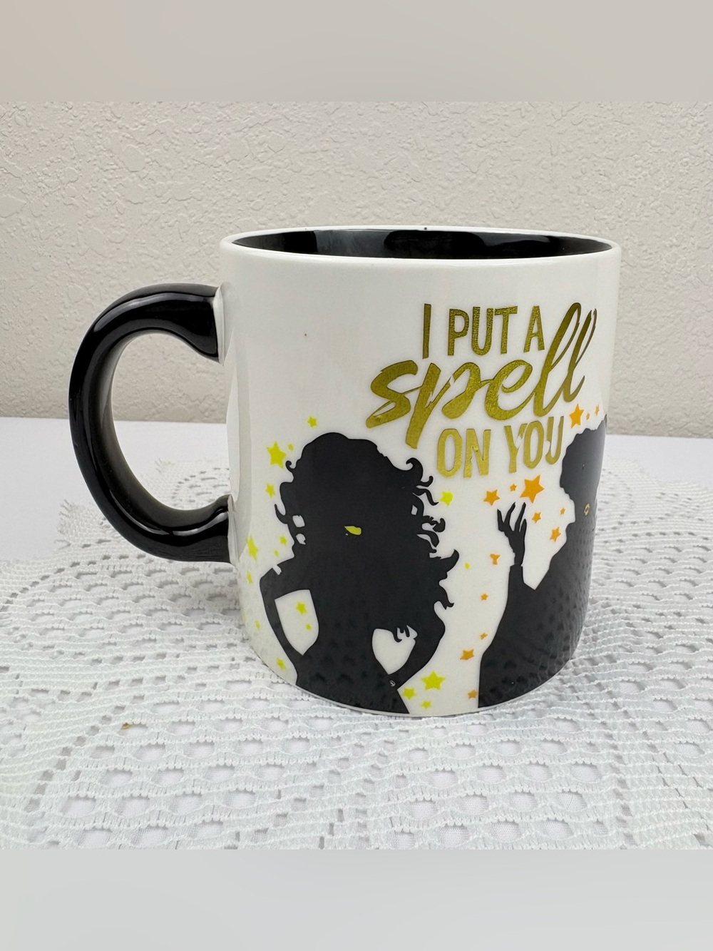 Disney Hocus Pocus Ceramic Mug with a Candle Inside the Mug.